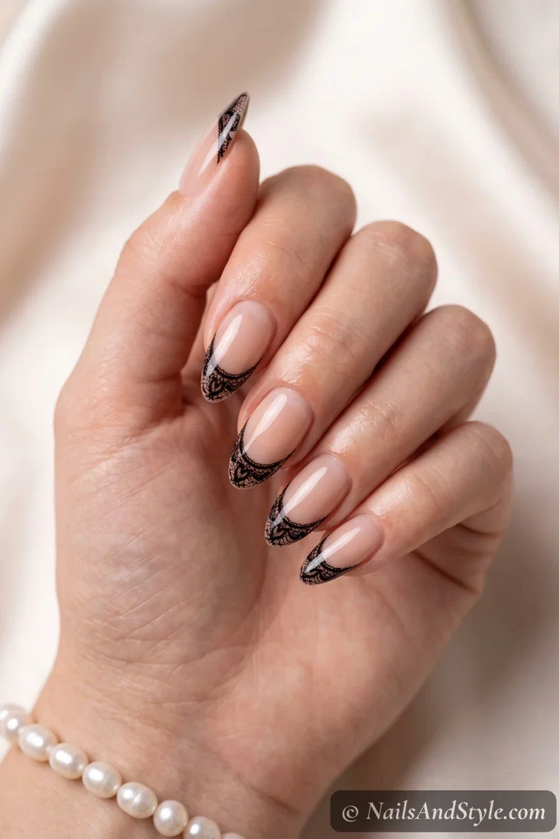 Sheer almond nails with black lace French tips