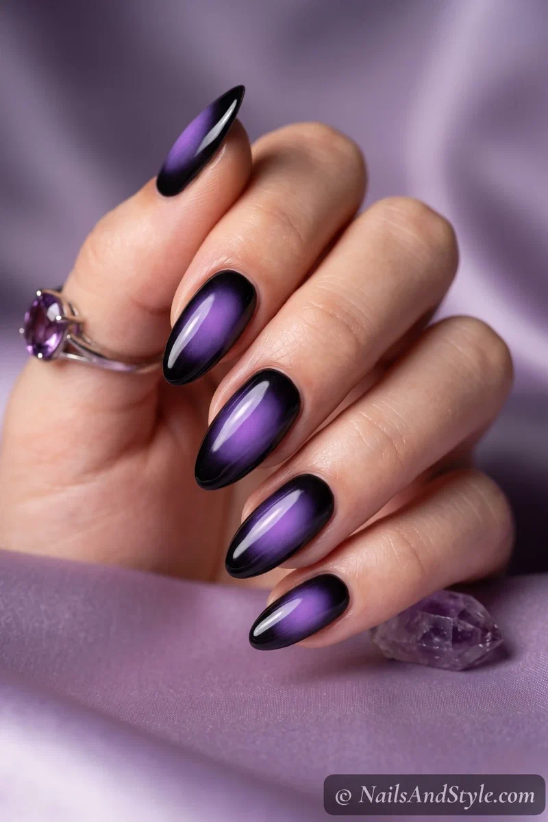 Black almond nails with a soft blurred purple aura glow