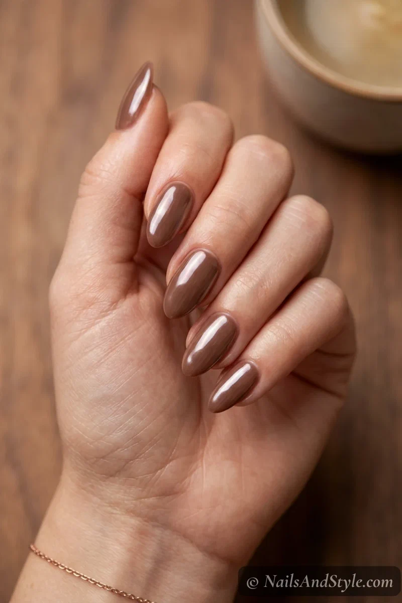 Mocha glaze nails with a milky chocolate brown base and pearly glazed chrome sheen on medium almond nails