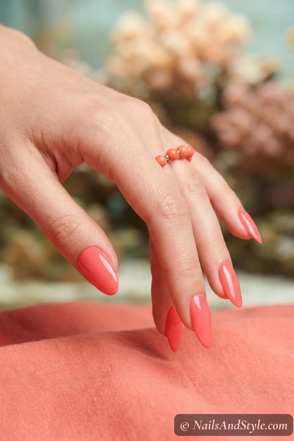 Bright coral glossy nails