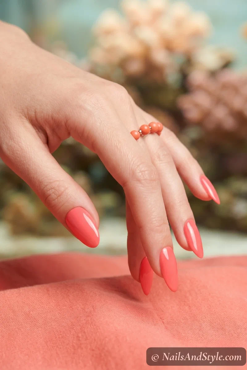 Bright coral solid color nails with glossy gel finish