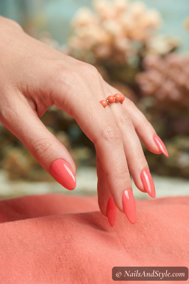 Bright coral solid color nails with glossy gel finish