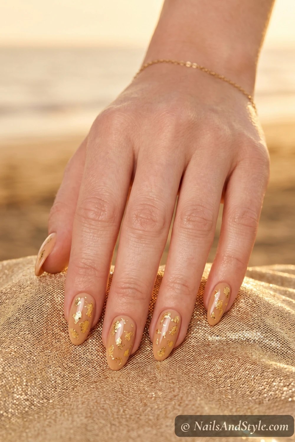 Sandy nude nails with gold flakes