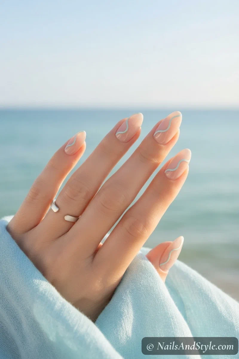 Nude bridal nails with thin aqua wave outline