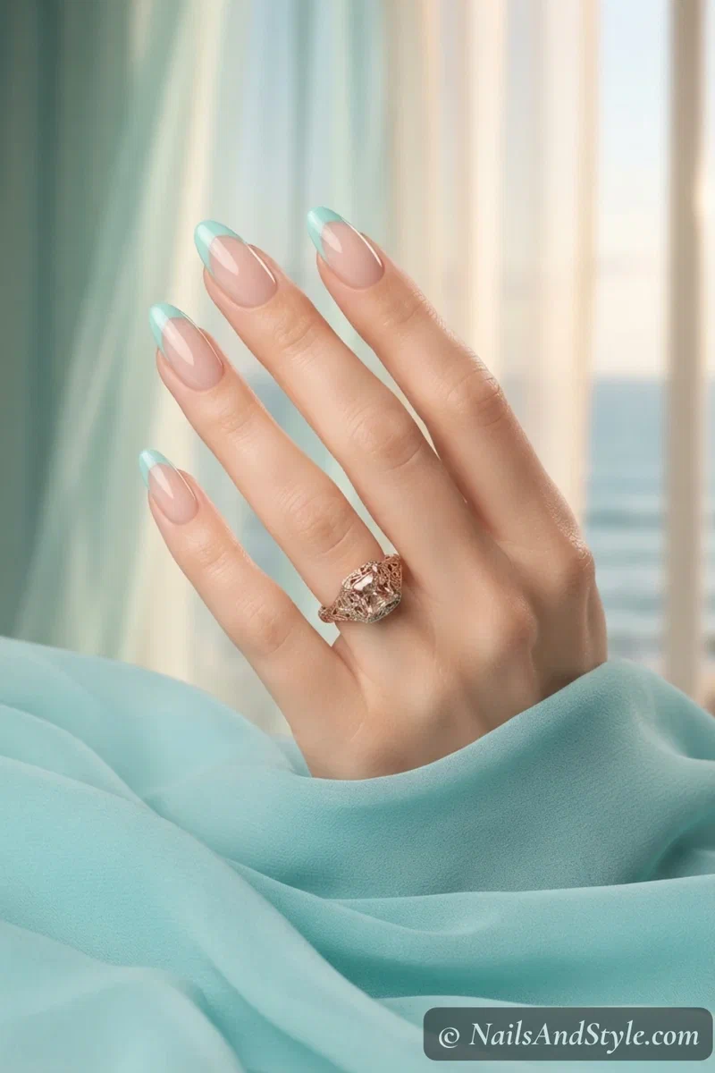 Sheer nude nails with soft aqua French tips