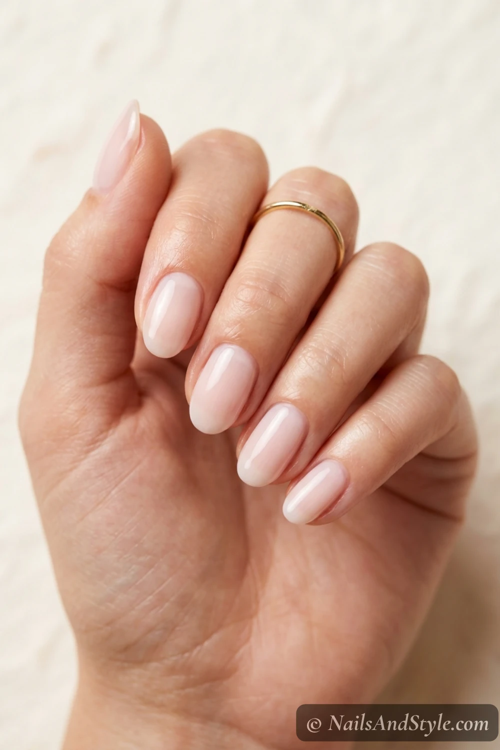 Sheer milky pale-pink oval nails