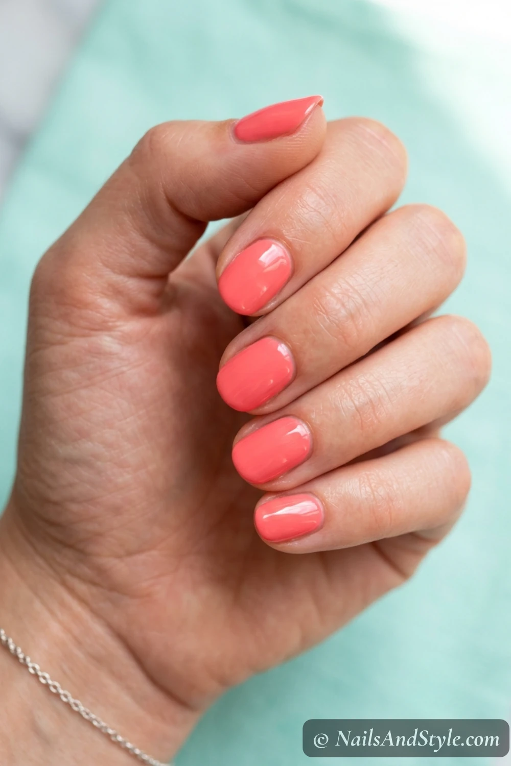 Bright coral-pink short round nails