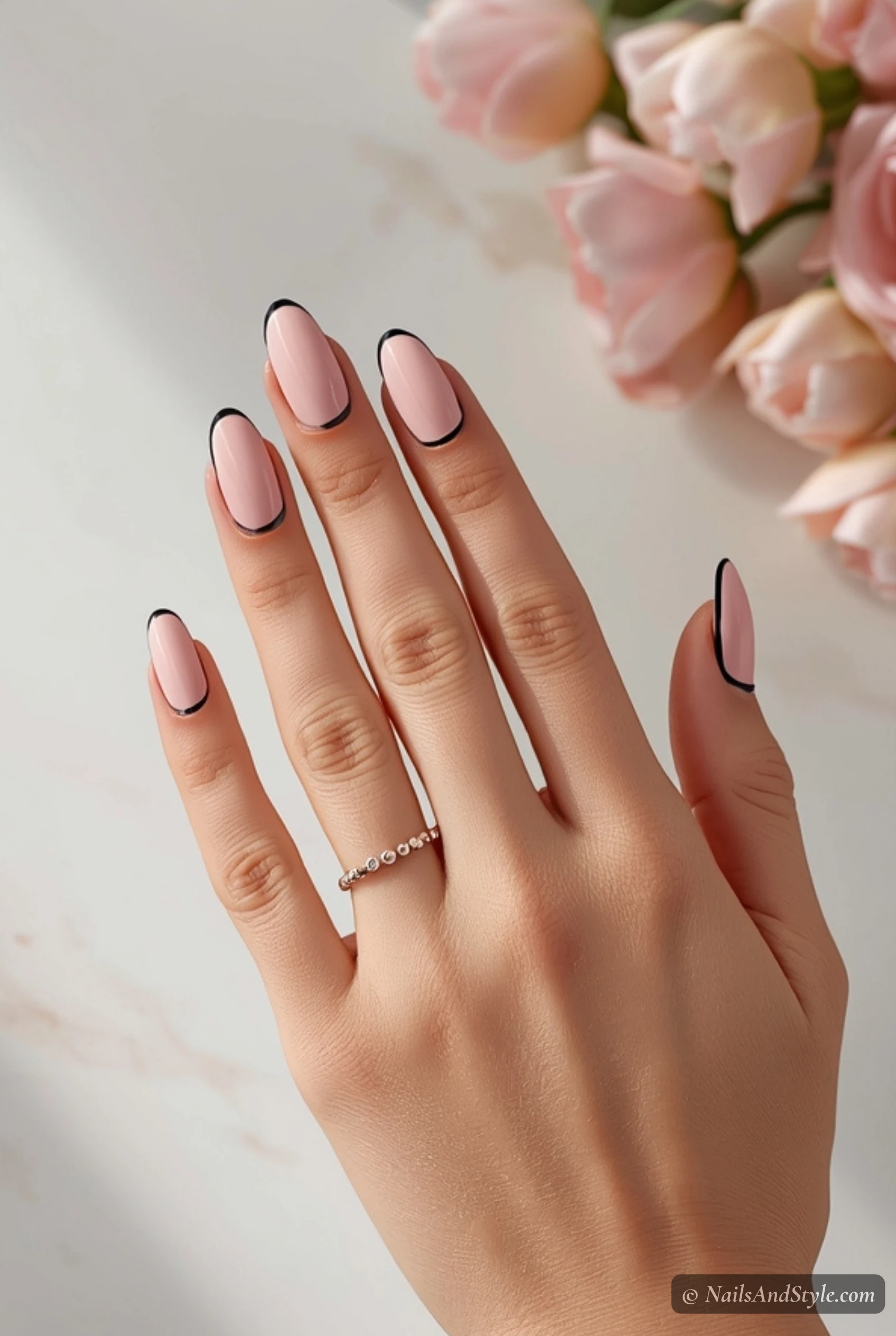 Black French tips on pink nails