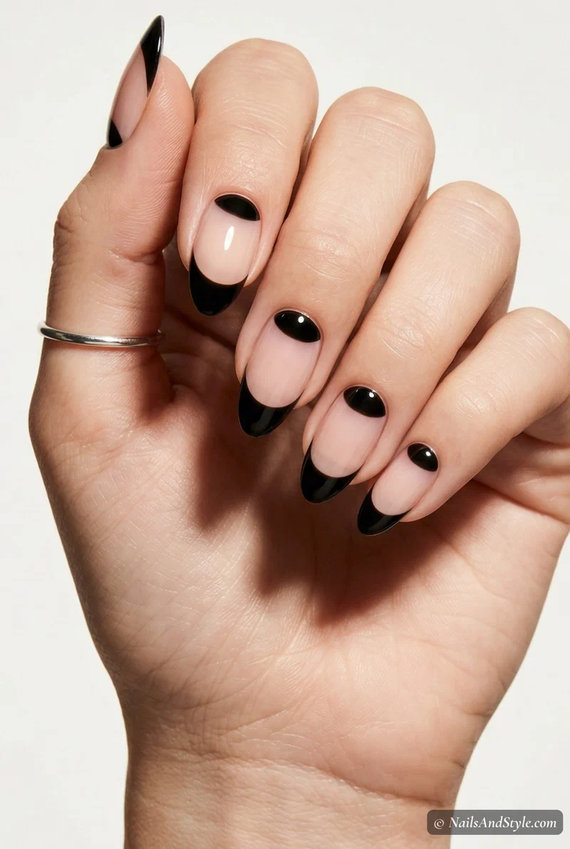 Negative space nails with black halfmoon details near the cuticle for spring