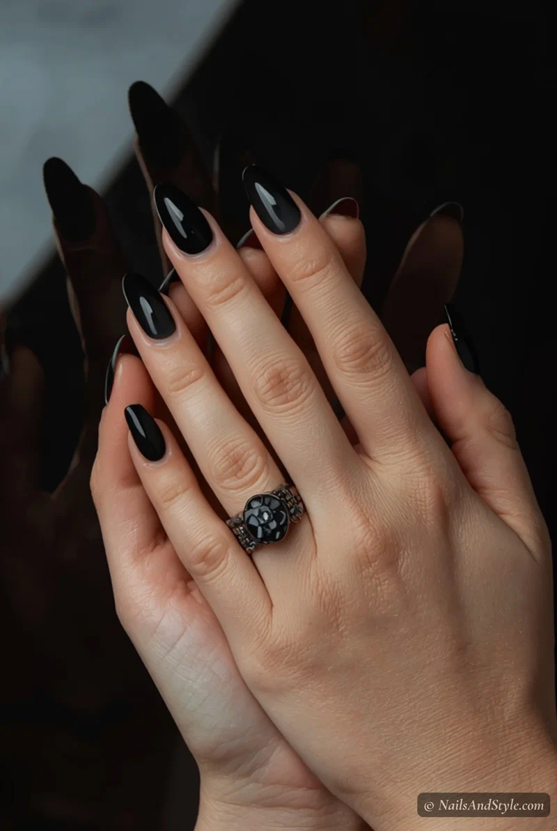 Smoky black ombre nails fading from dark tips to a nude base for spring