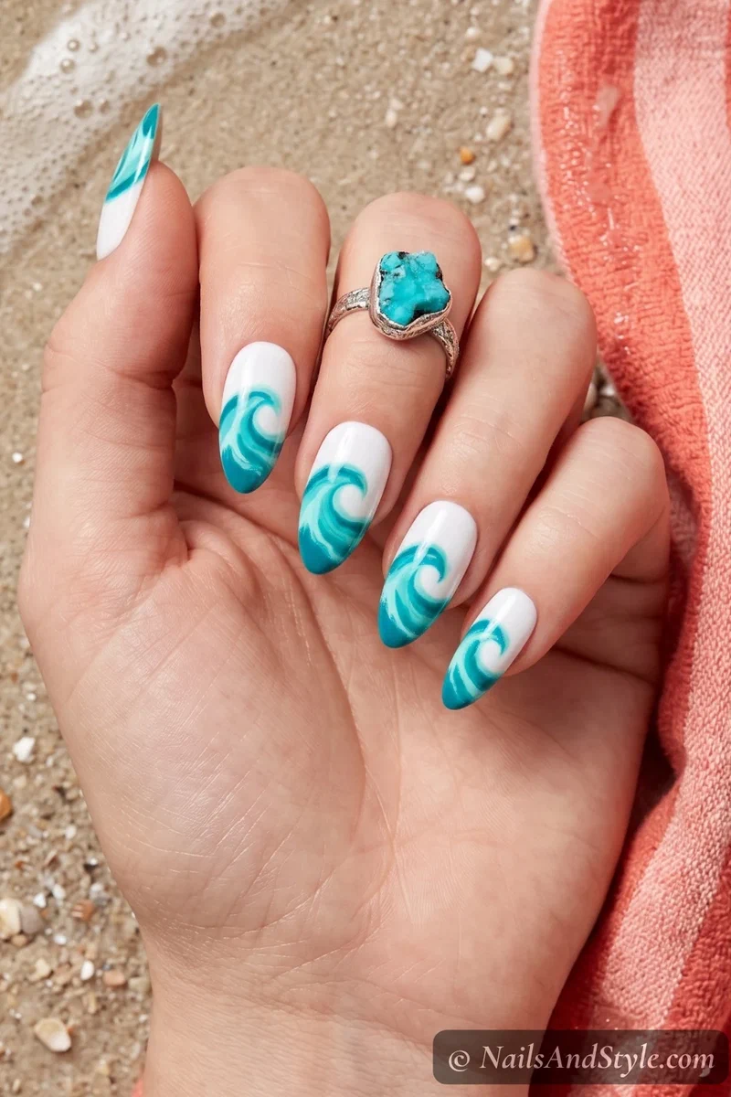 Turquoise blue nails with painted ocean wave details on almond shaped nails