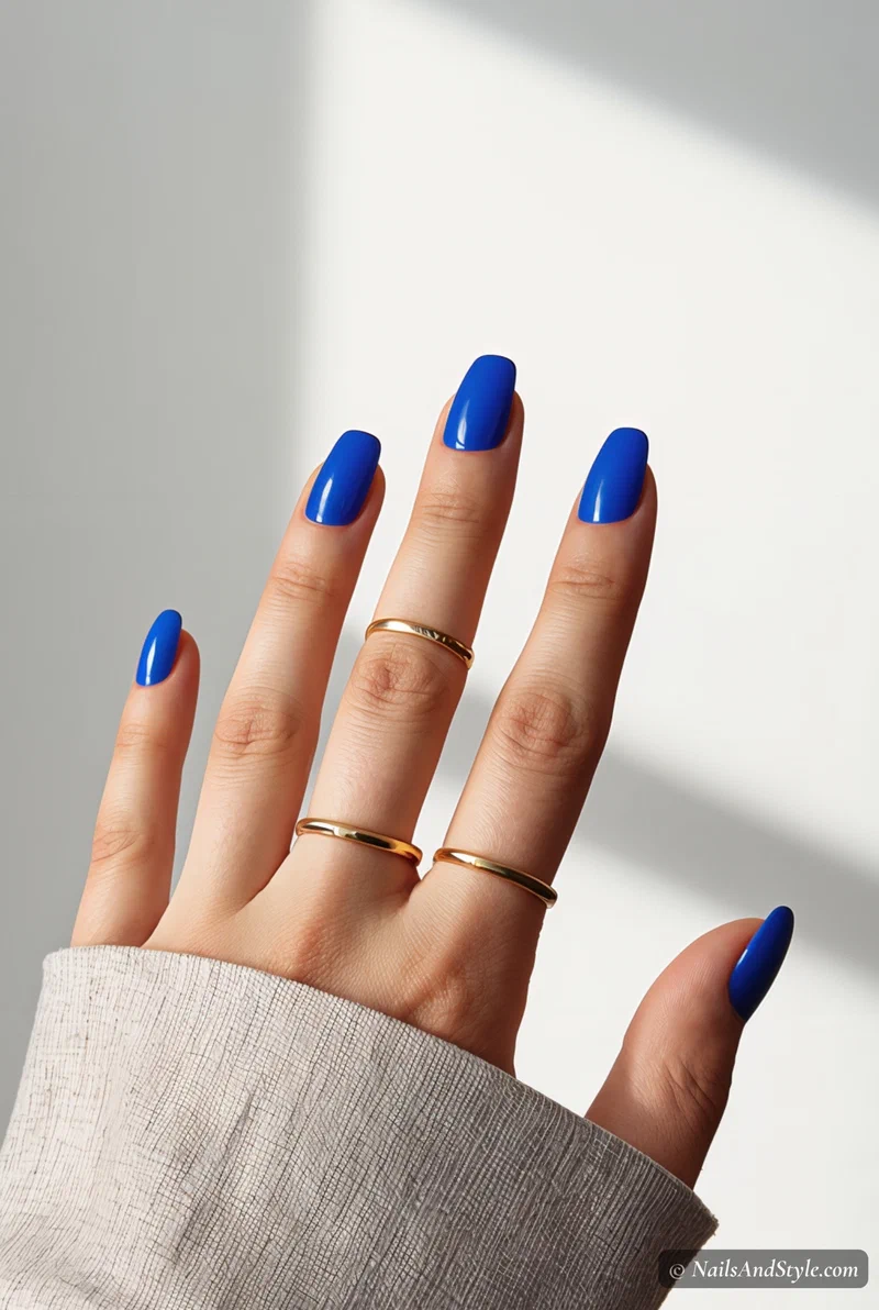 Electric blue nails on short round nails with glossy finish