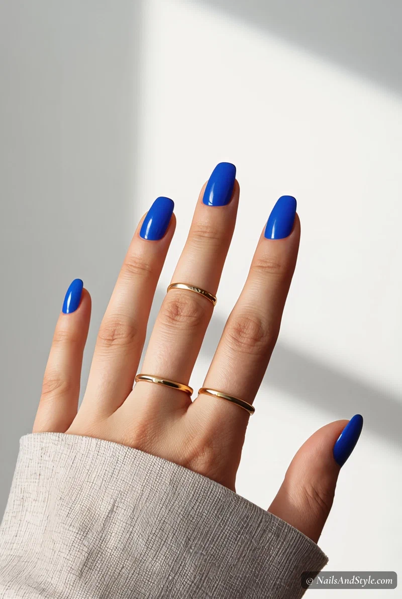 Electric blue nails on short round nails with glossy finish