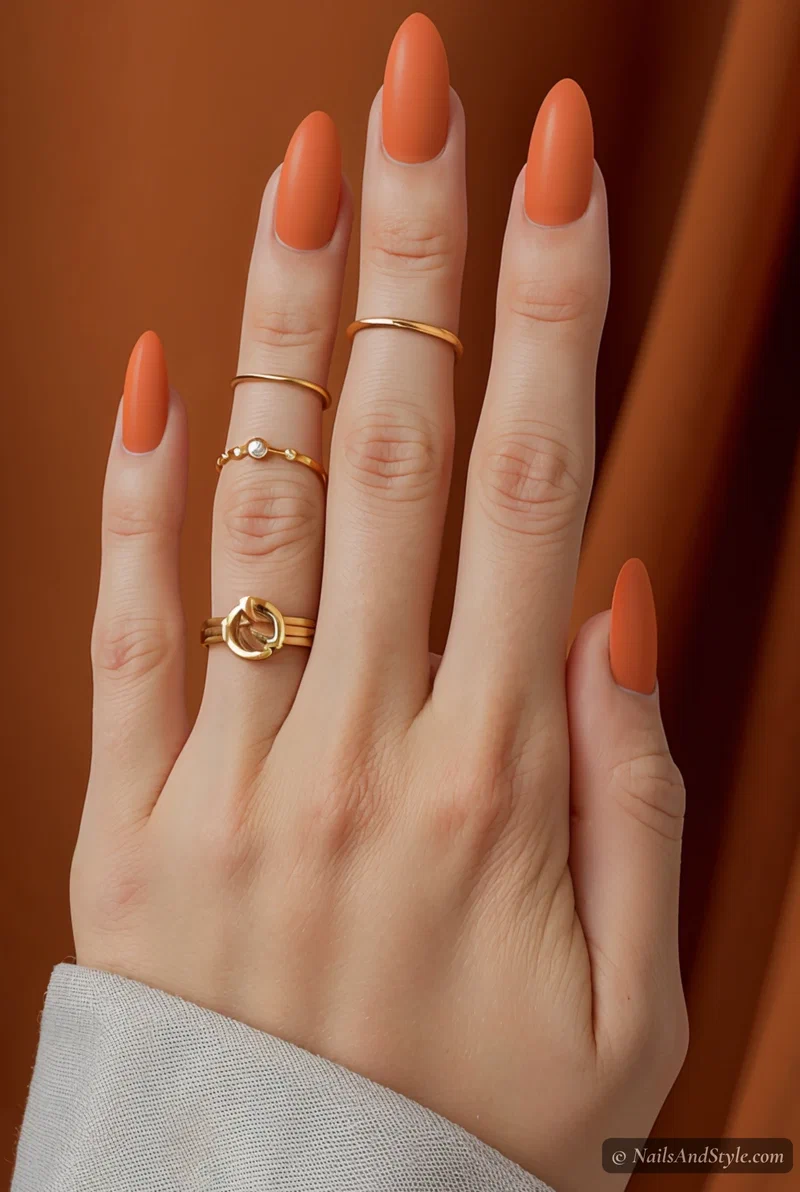 Matte tangerine orange nails on short almond nails