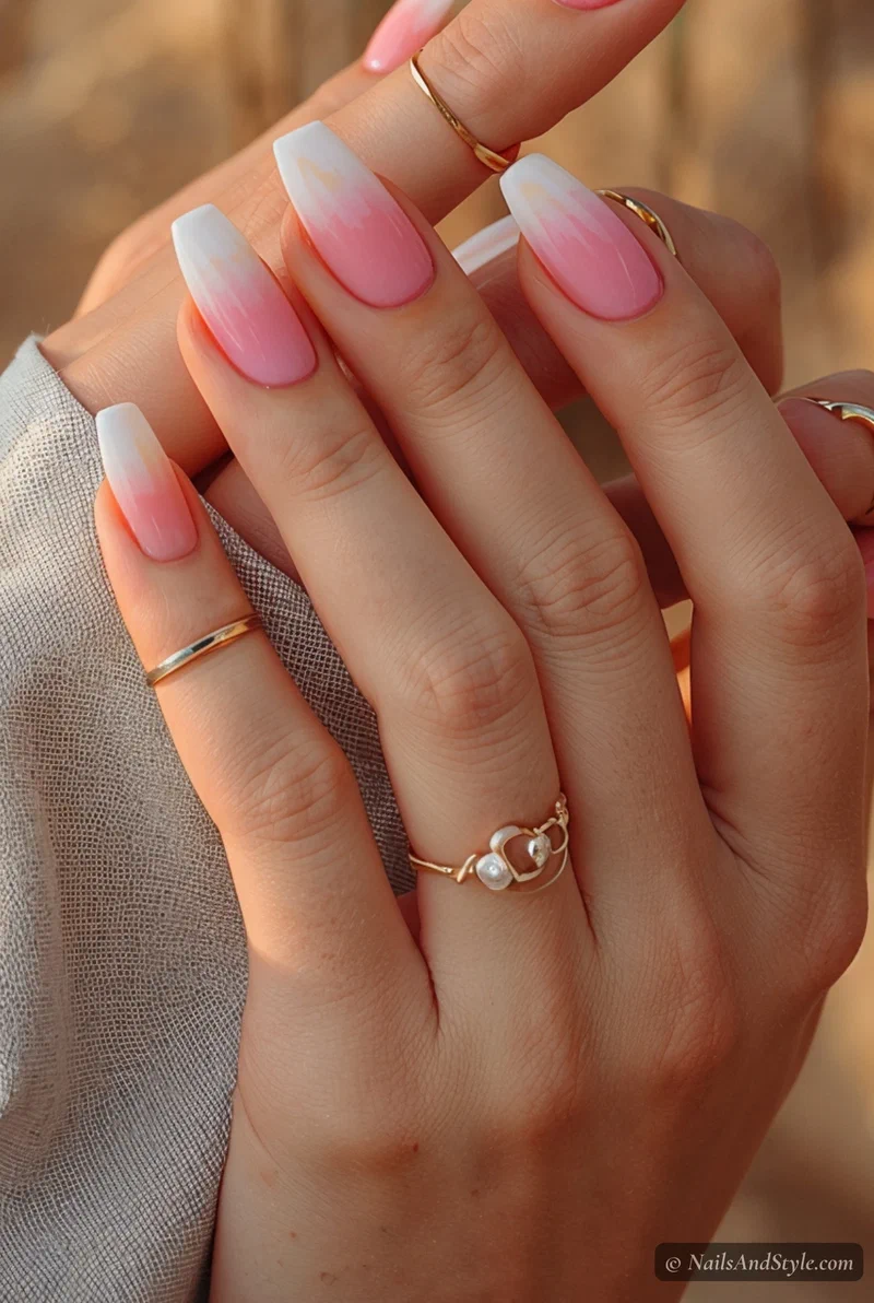 Tropical sunset ombre nails with pink and orange gradient on medium almond nails