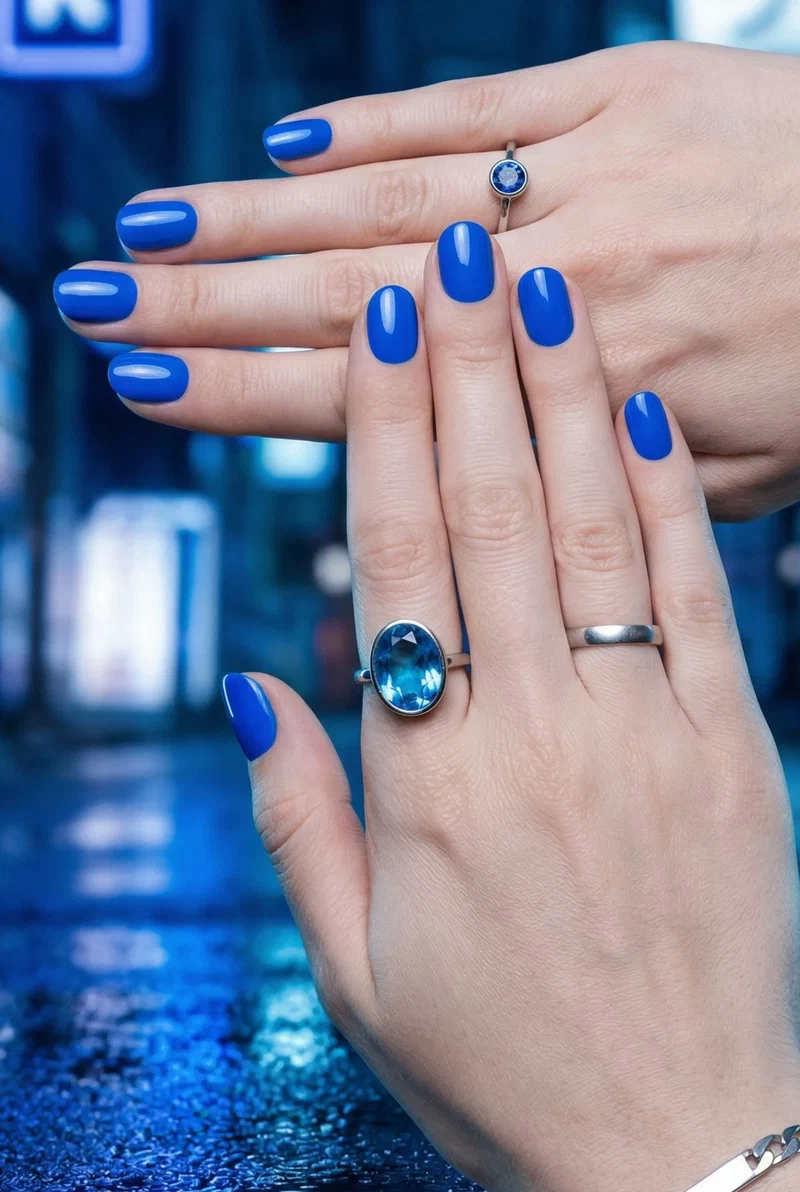 Electric blue nails on short round nails with glossy finish