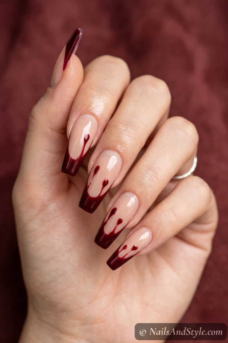 Long nude coffin nails with dark red French tips dripping like blood