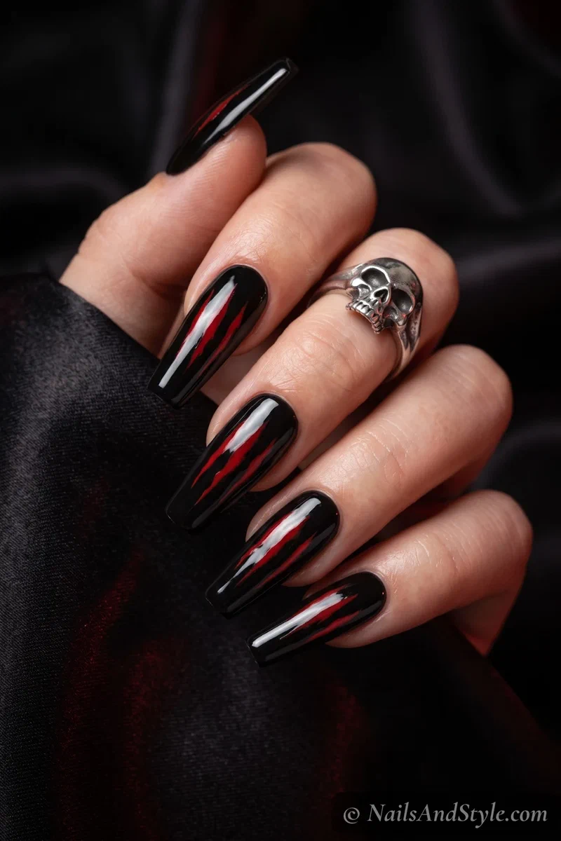 Long black coffin nails with red claw scratch marks