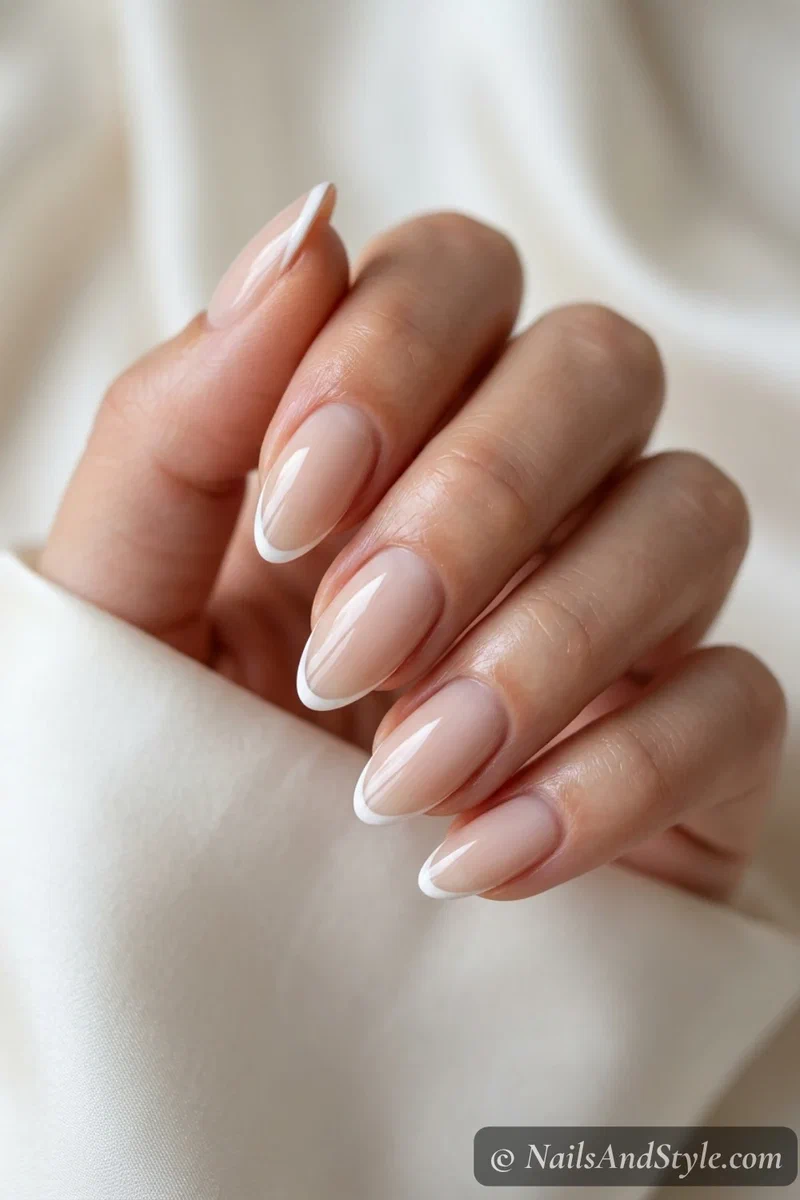 Milky nude nails with a very thin white French tip
