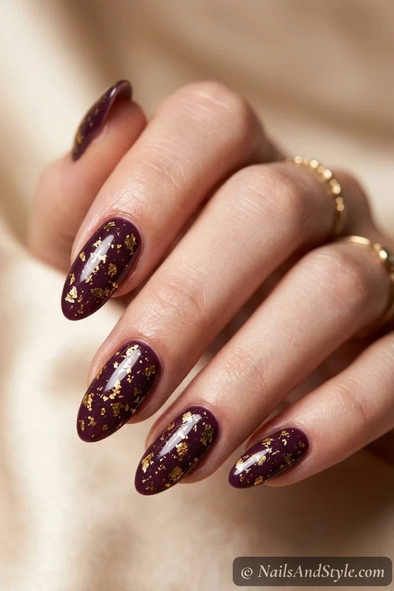 Plum nails with gold foil flakes