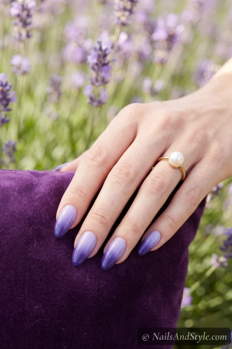 Blueberry ombre gradient nails fading from pale lavender to deep blueberry on medium almond nails