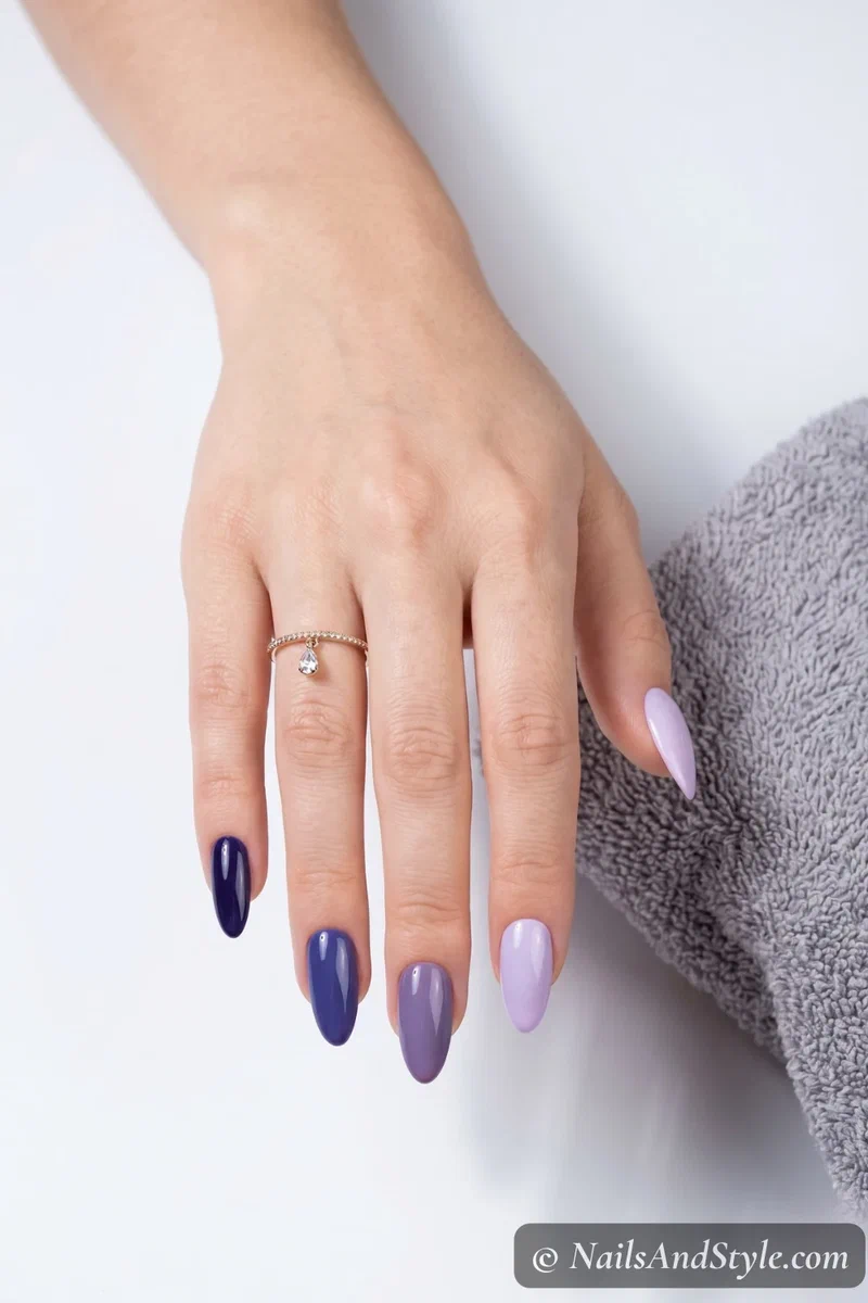 Five-shade blueberry to lavender gradient across all five nails on almond shaped nails