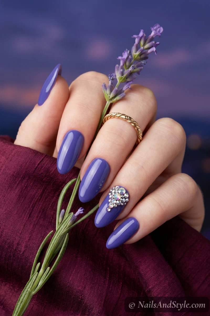 Blueberry nails with iridescent rhinestone cluster accent on medium almond nails