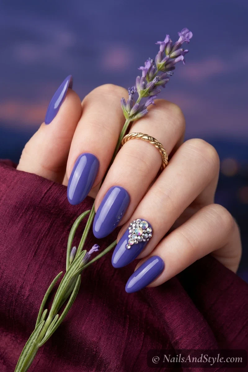 Blueberry nails with iridescent rhinestone cluster accent on medium almond nails
