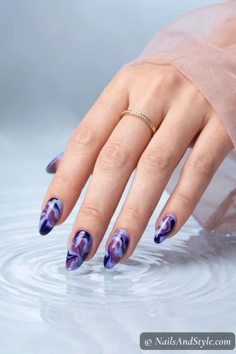 Blueberry purple swirl nail art with mixed berry tones on medium almond nails