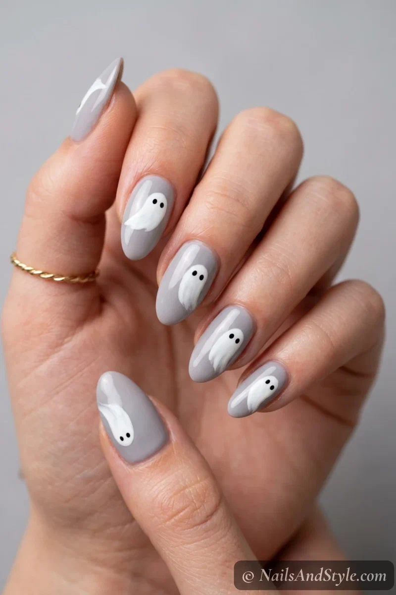 Soft grey nails with a simple one-stroke white ghost with dot eyes