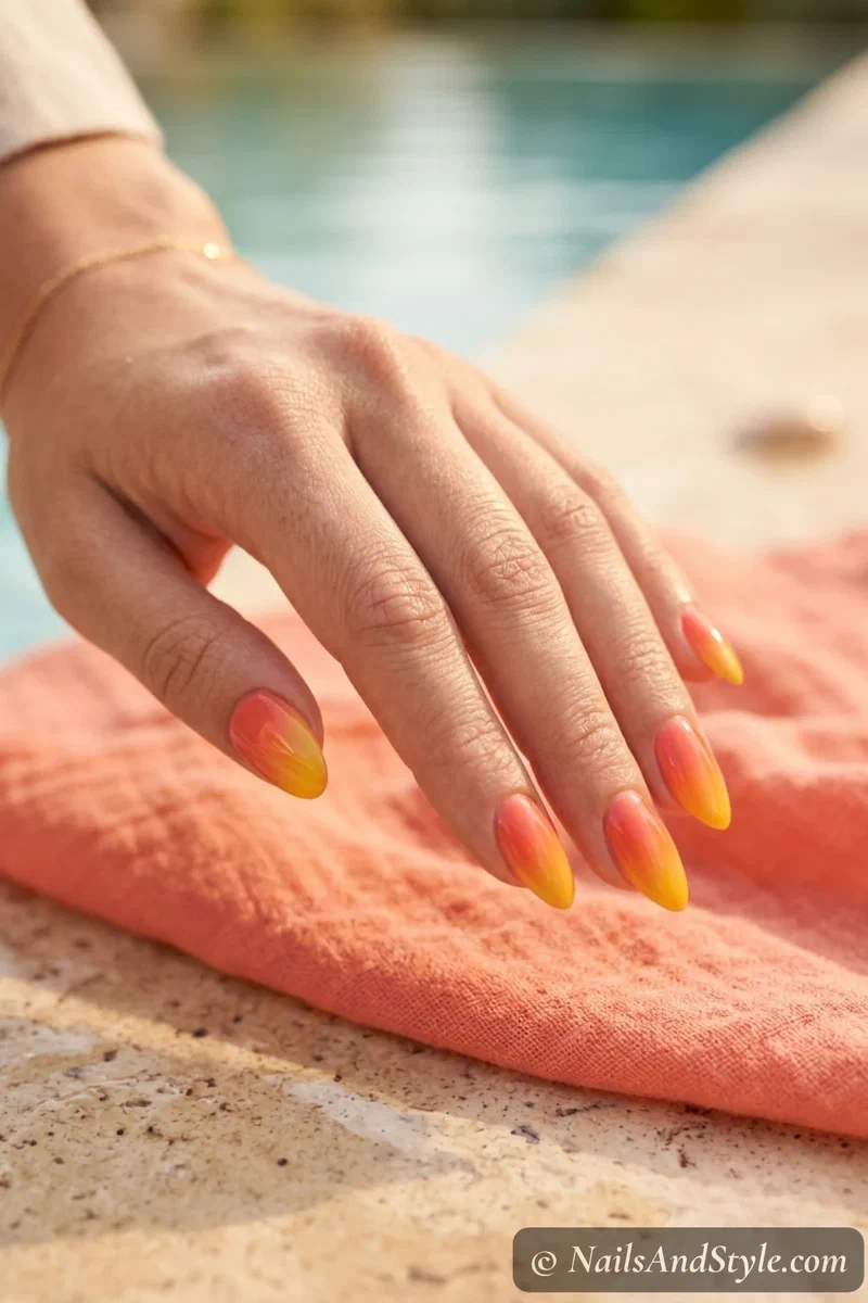 Golden hour ombre nails blending warm coral into golden yellow on medium almond nails