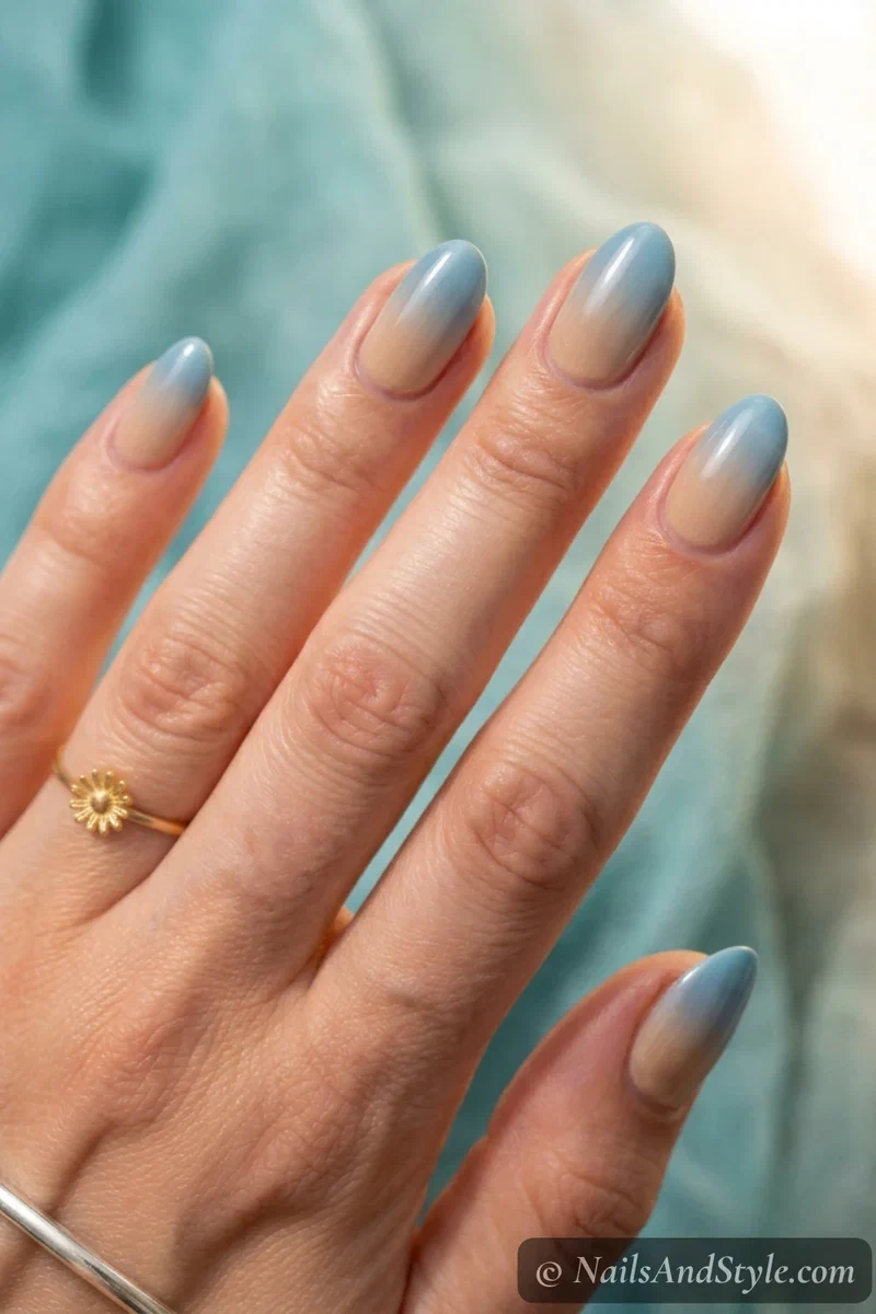 Ocean to sand ombre nails fading soft ocean blue into warm sandy beige on medium almond nails