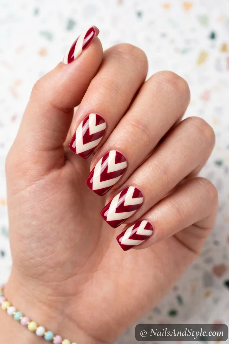Chevron team stripe nails with zigzag stripes in two team colors on medium squoval nails