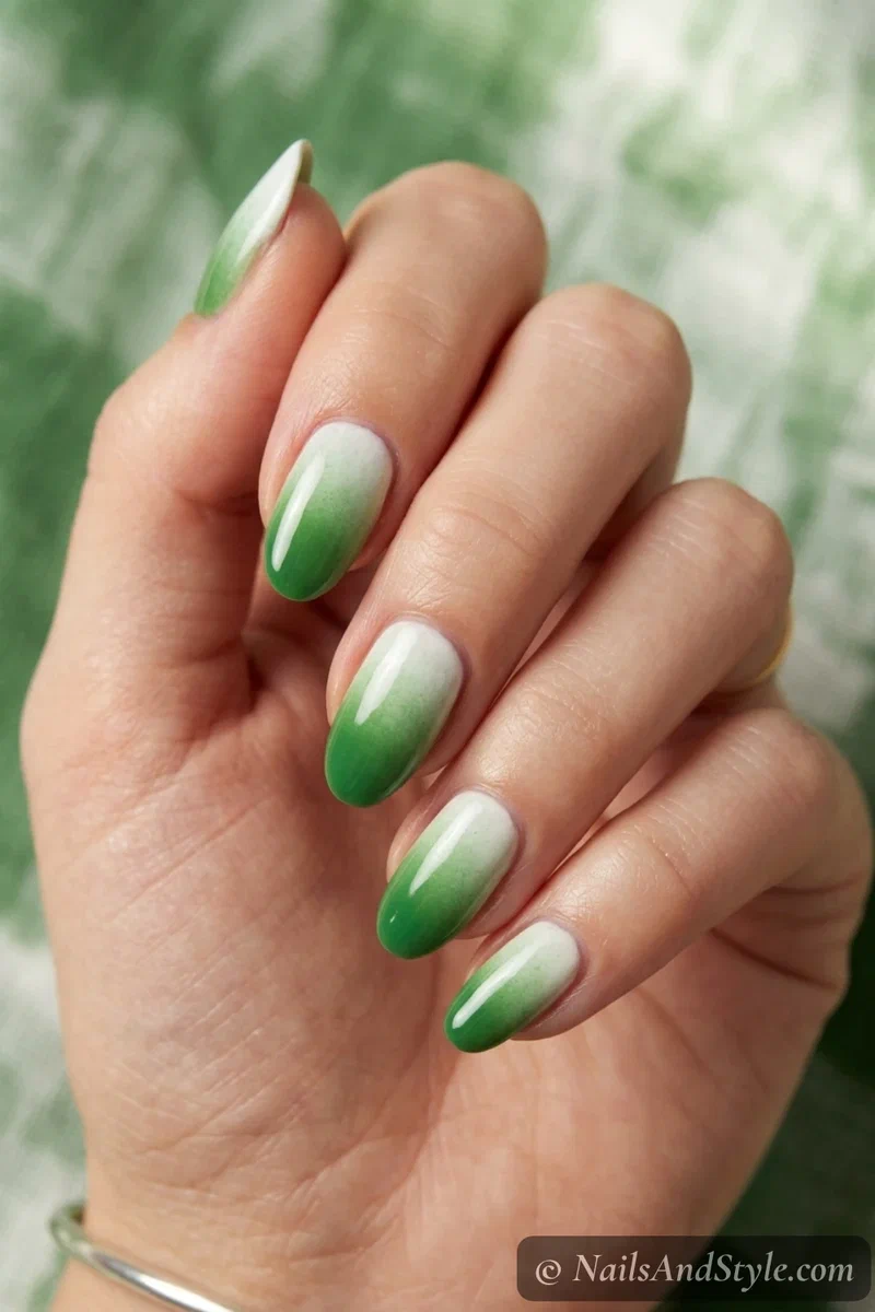 Grass and chalk ombre nails fading grass green into chalky white on medium almond nails