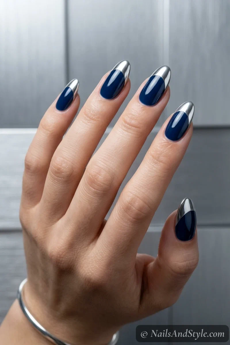 Metallic silver tip nails with mirror silver tips over a team-color base on medium almond nails