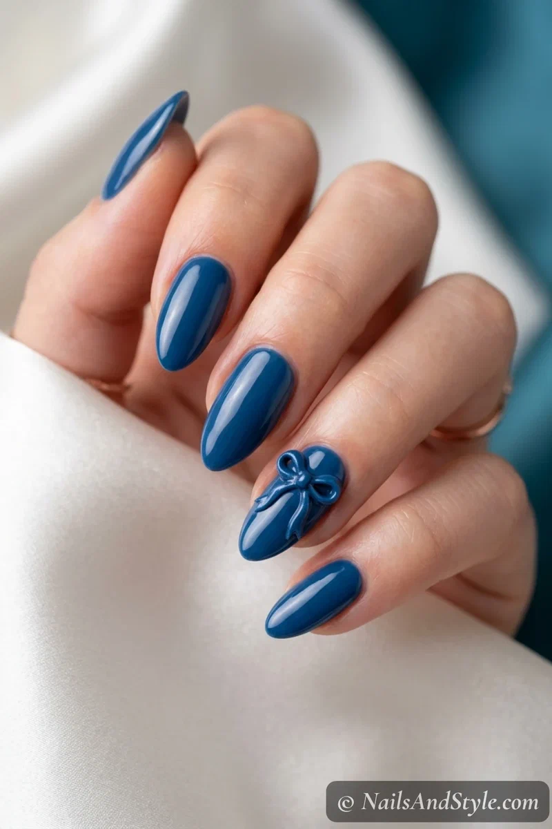 Spirit ribbon accent nails with a small team-color ribbon bow on one accent nail, medium almond nails