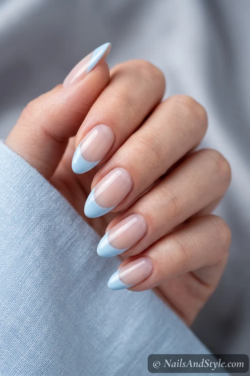 Sheer base nails with pastel baby blue French tips
