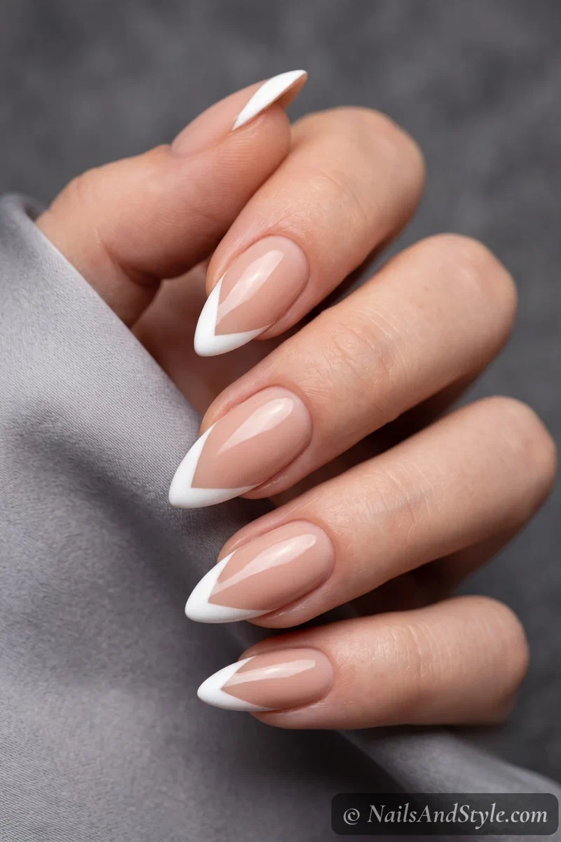 Nude nails with sharp V-shaped chevron French tips
