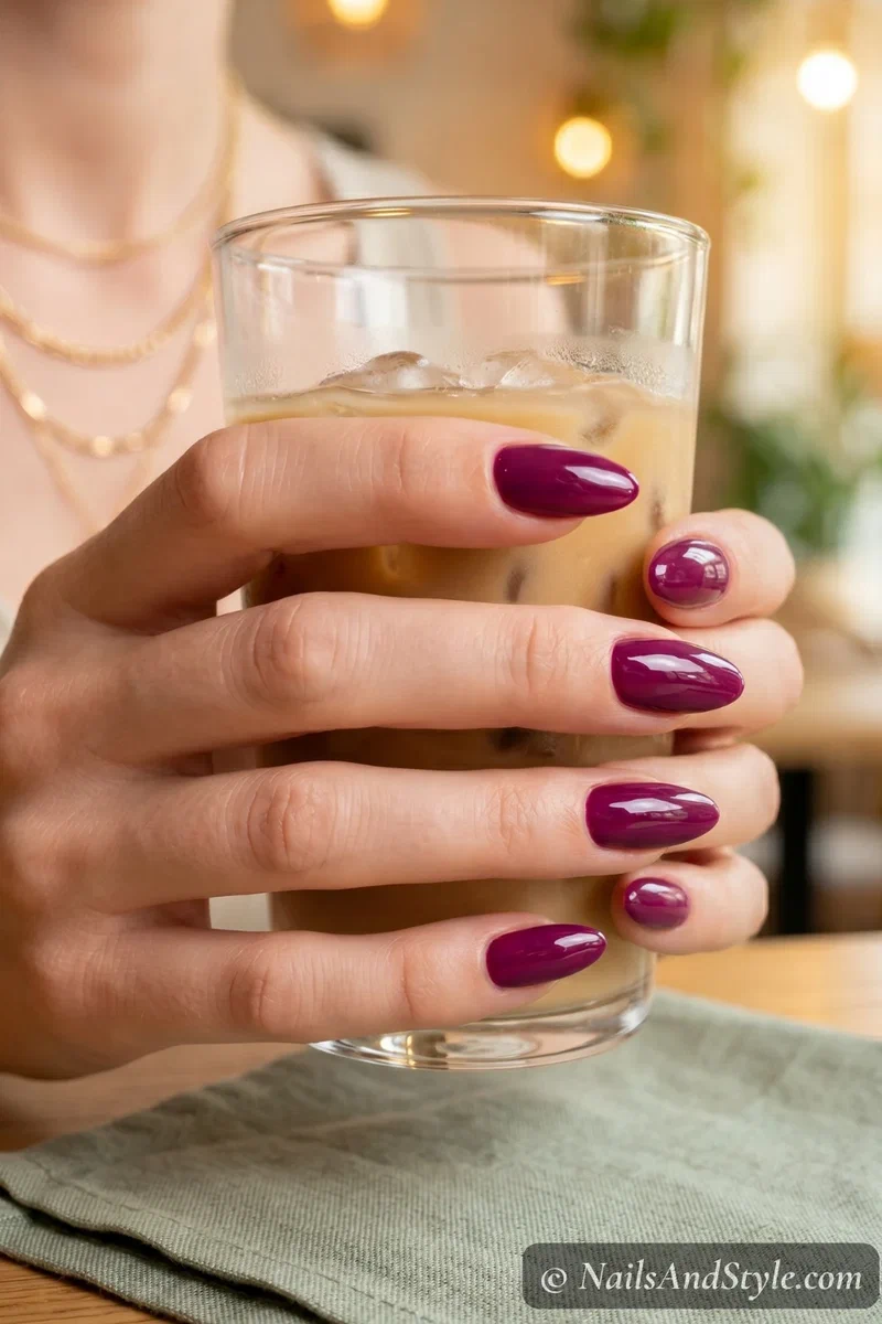 Rich berry hybrid gel polish on medium almond nails showing thick glossy gel-like finish