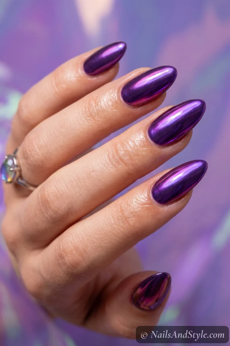 Iridescent purple chrome nails shifting between violet and magenta