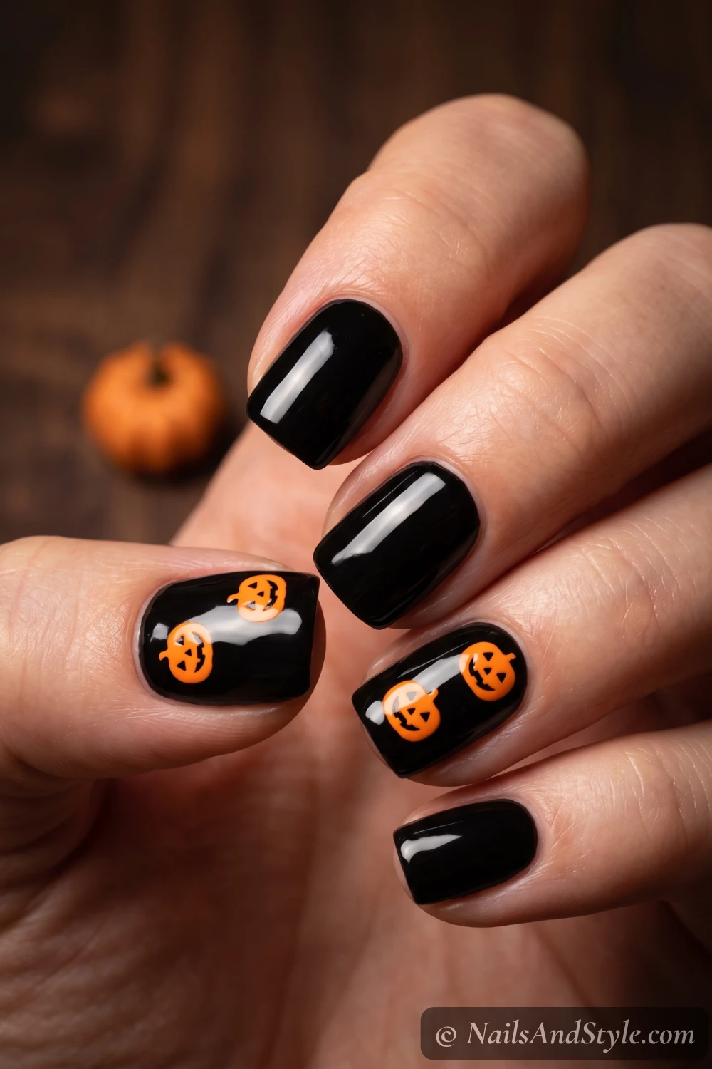 Glossy black nails with pumpkin decals