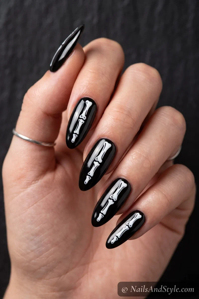 Black nails with white skeleton bone decals running down each nail