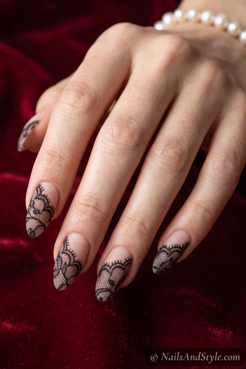 Sheer almond nails with delicate black lace detailing