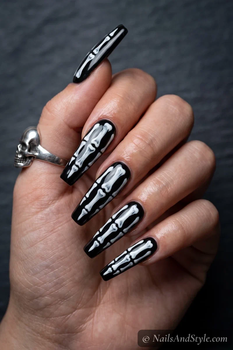 Long black coffin nails with detailed white skeleton bones