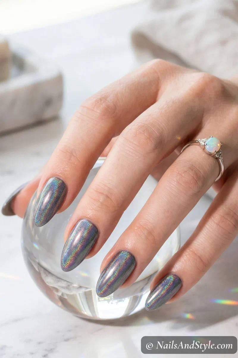 Holographic rainbow chrome nails showing prismatic color shift on medium almond nails