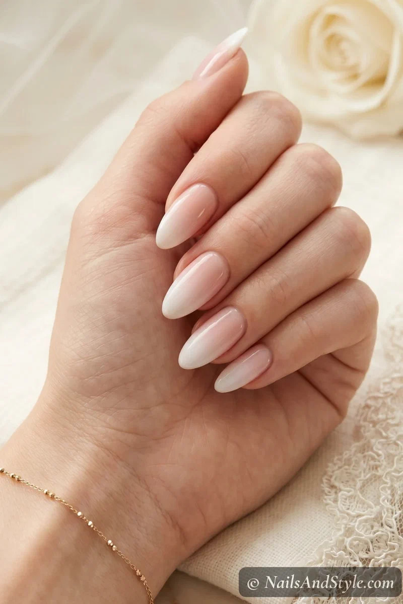 Baby boomer acrylic nails with sheer pink to white gradient