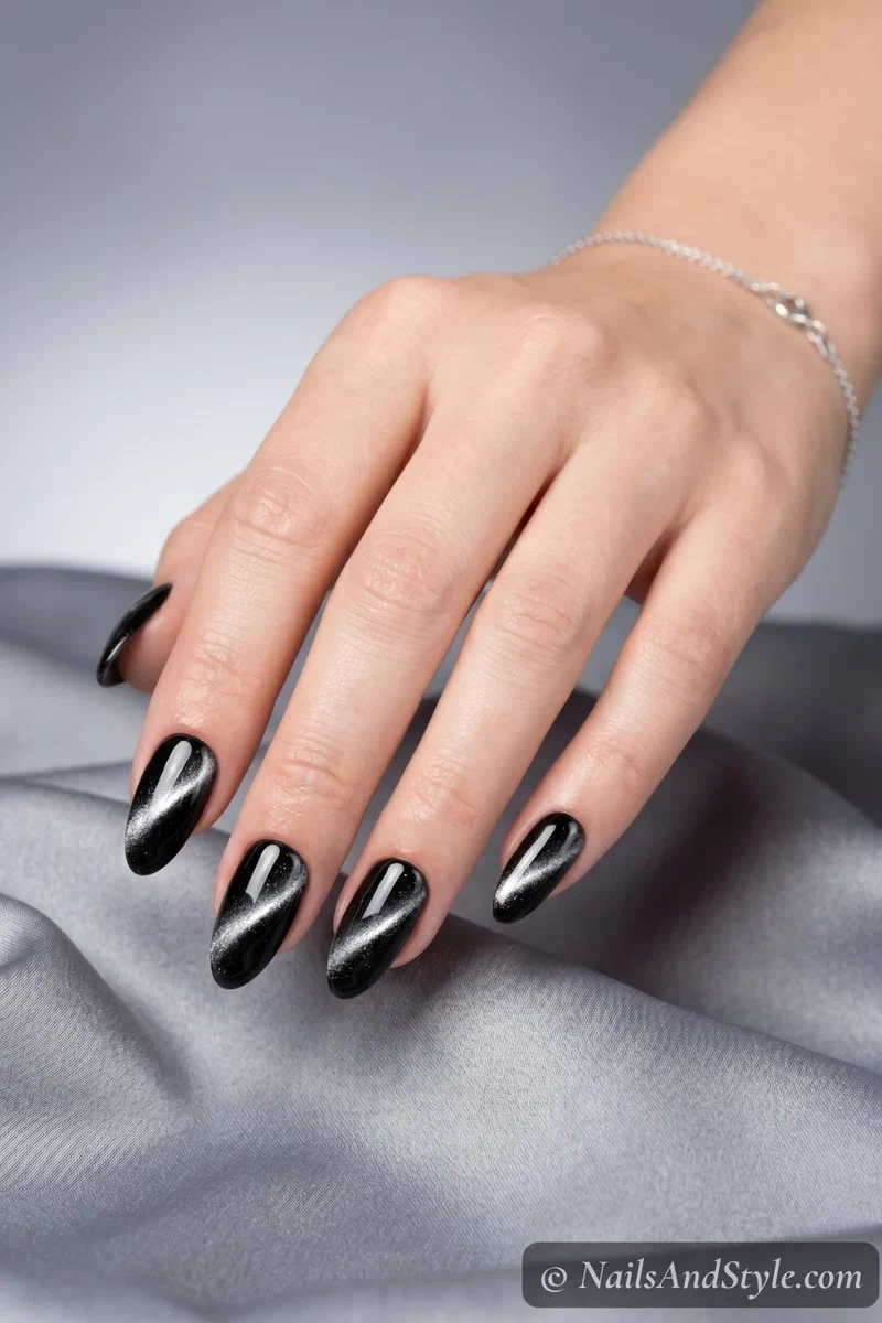 Classic silver cat eye nails with diagonal shimmer line on black base