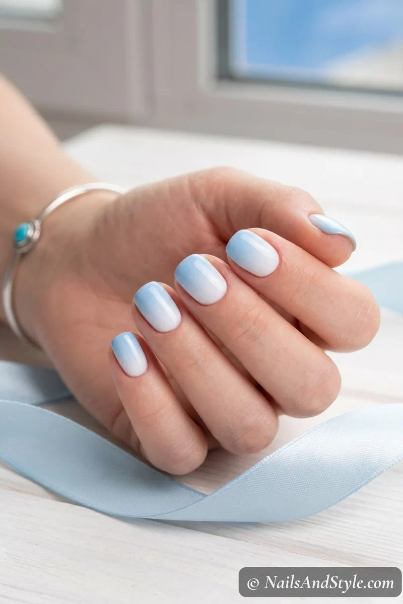 Baby blue to white sponge ombre nails on short round nails