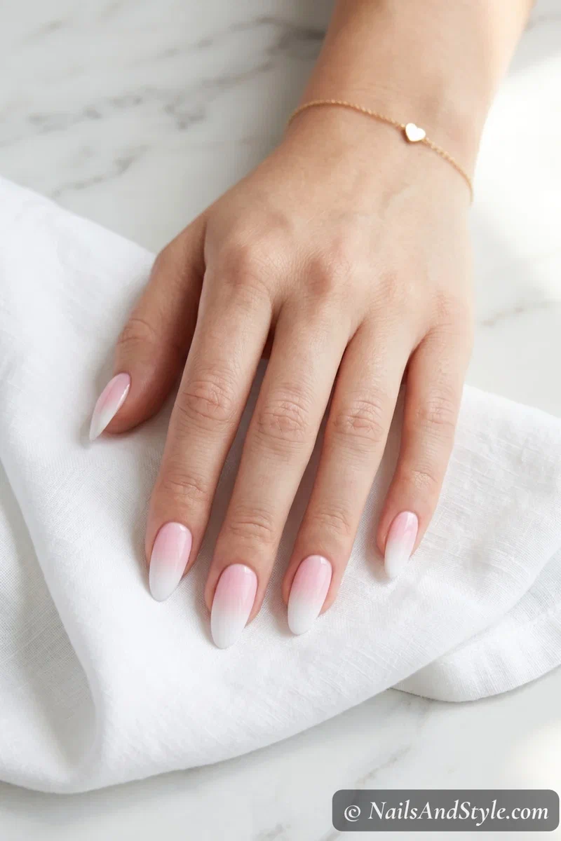 Classic pink to white ombre fade on medium almond nails with glossy finish