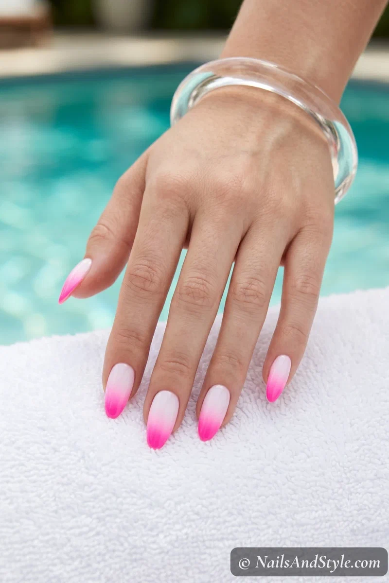 Neon electric pink gradient fading into white on medium almond nails